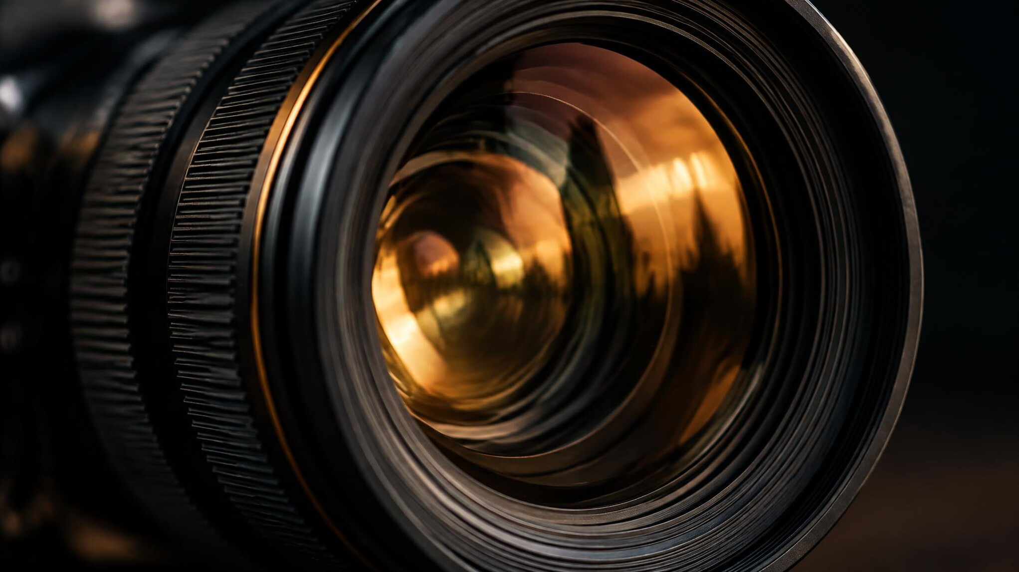 Close-up of a camera lens with warm reflections